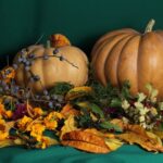 A vibrant autumn arrangement featuring pumpkins, leaves, berries, and flowers, perfect for fall-themed designs.