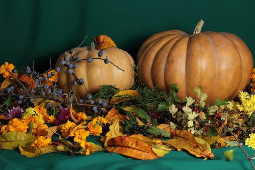 A vibrant autumn arrangement featuring pumpkins, leaves, berries, and flowers, perfect for fall-themed designs.