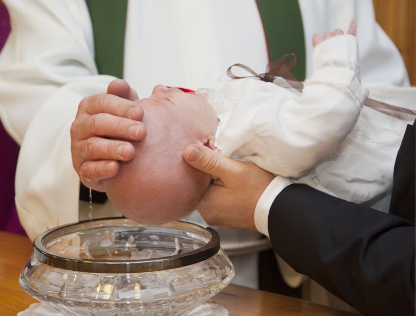 the-dew-the-priest-christening-38999-38999 A baby being baptized during a ceremonial Christian baptism, featuring a priest and holy water.